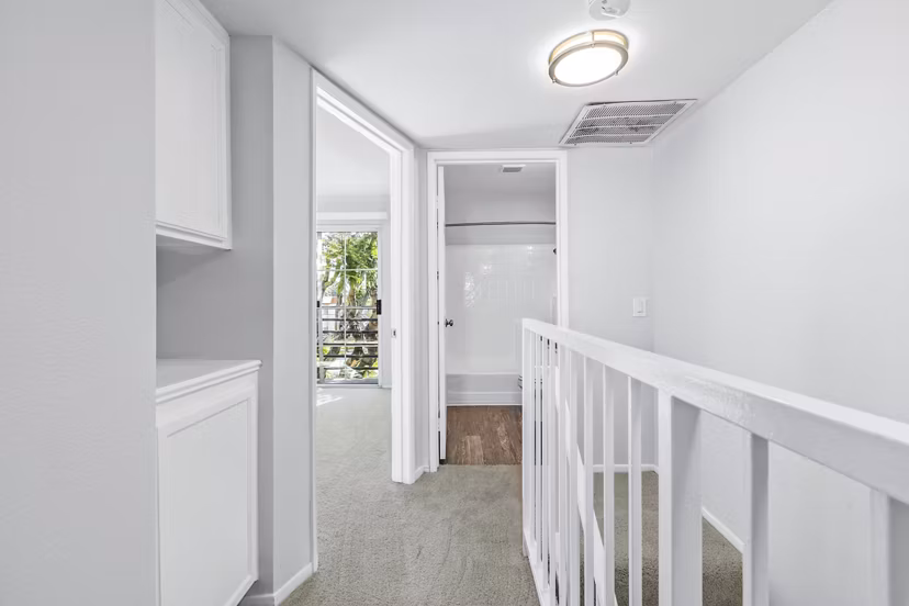 Nova Townhomes Apartments: Modern hallway and stairway design with sleek lines and ambient lighting