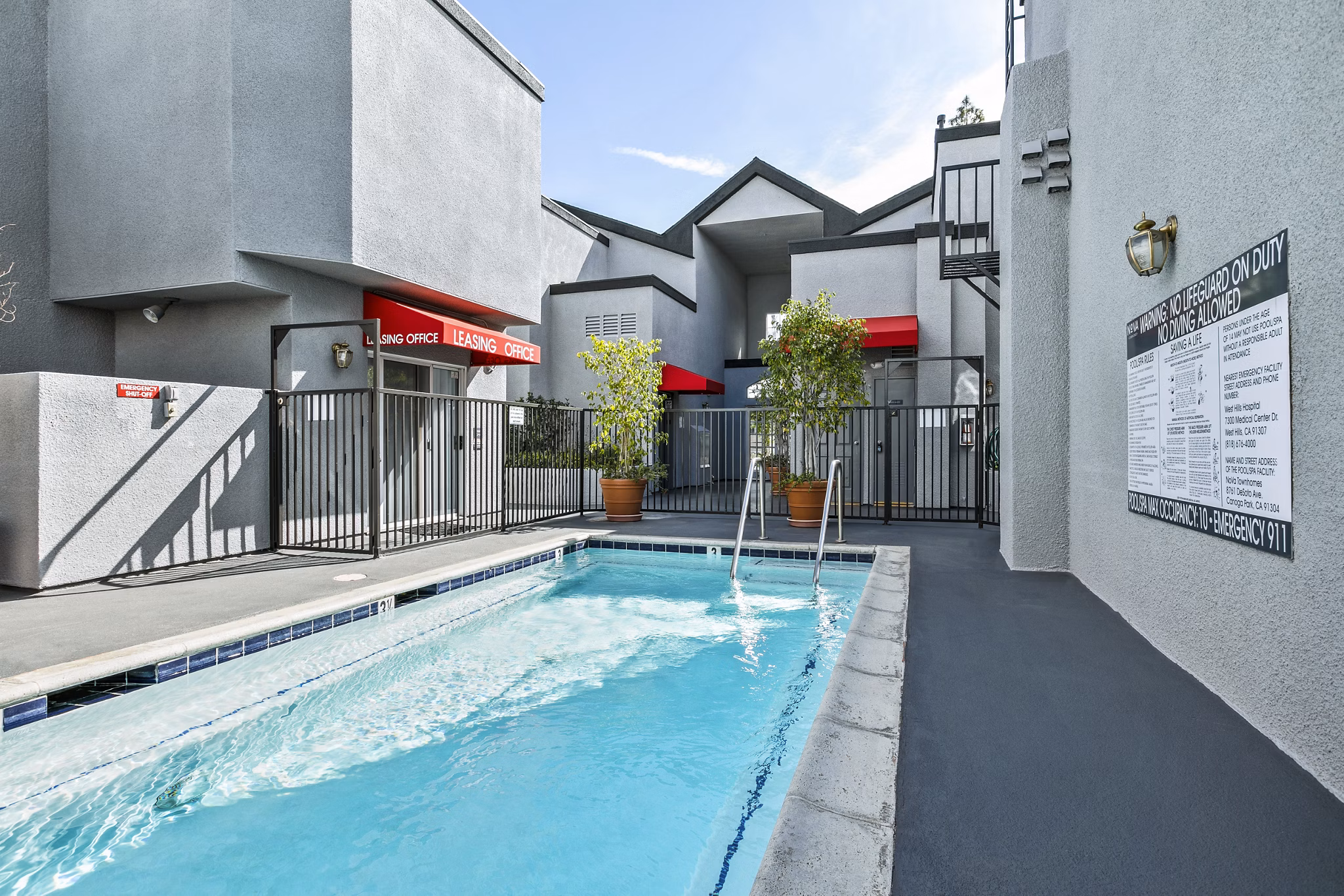 Relaxing outdoor pool with sundeck at Nova Townhomes Apartments, offering luxury living in a vibrant community setting