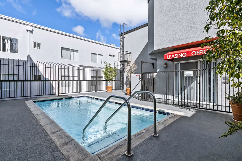 Elegant outdoor pool with modern seating area at Nova Townhomes Apartments, designed for relaxation and leisure activities