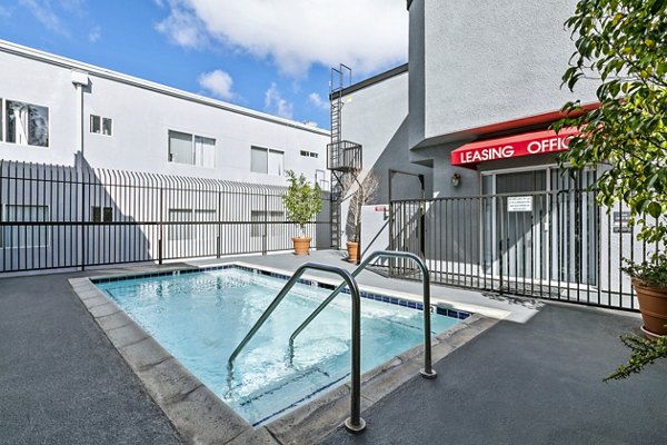 Elegant outdoor pool with modern seating area at Nova Townhomes Apartments, designed for relaxation and leisure activities