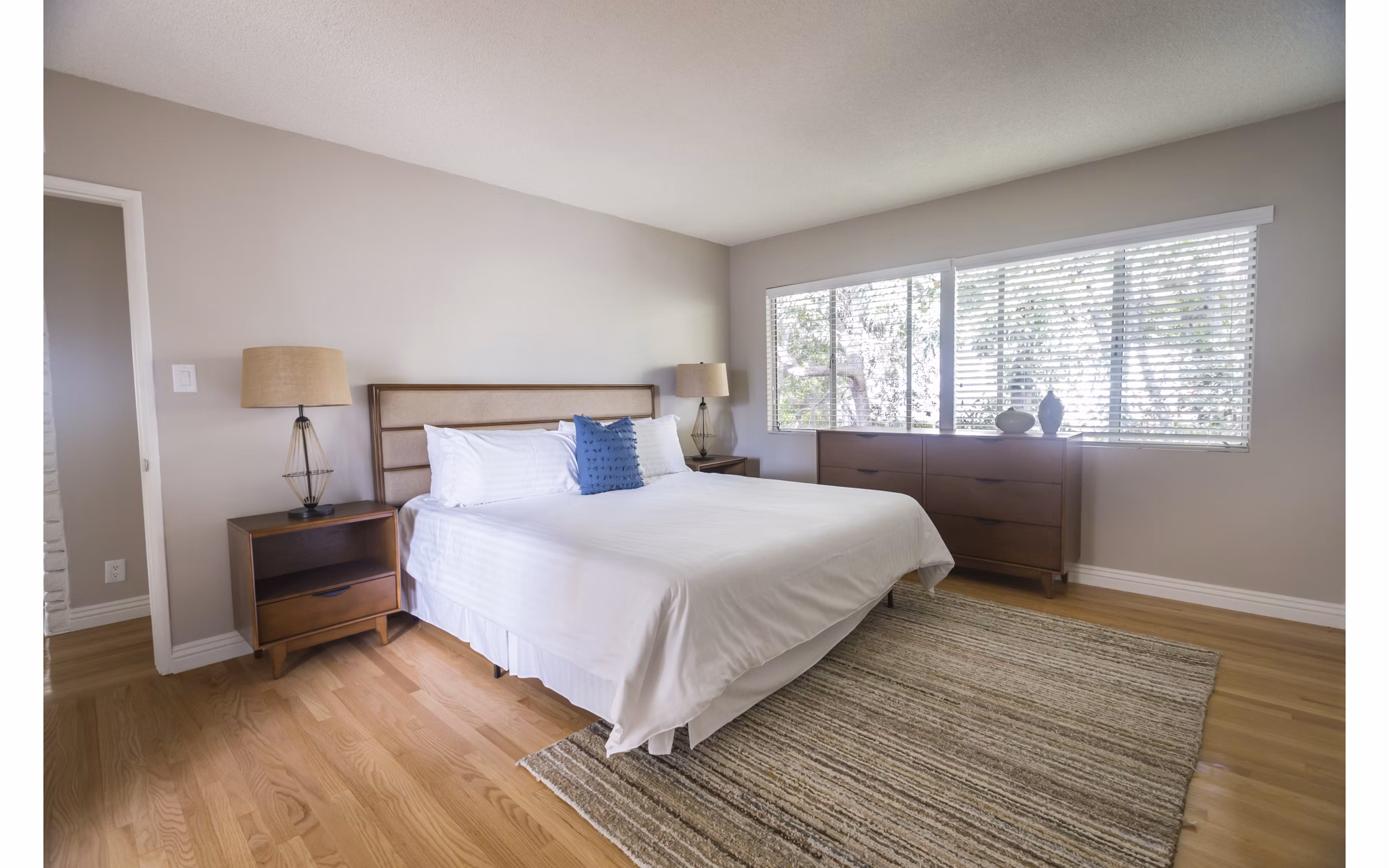 Cozy bedroom with modern furnishings at Orange Grove Circle Apartments