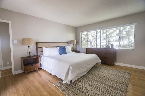 Cozy bedroom with modern furnishings at Orange Grove Circle Apartments