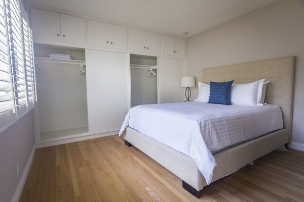 Bedroom with modern decor and ample natural light at Orange Grove Circle Apartments