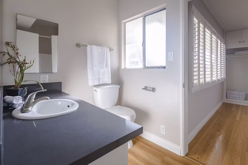Bathroom with elegant marble countertops and modern fixtures at Orange Grove Circle Apartments