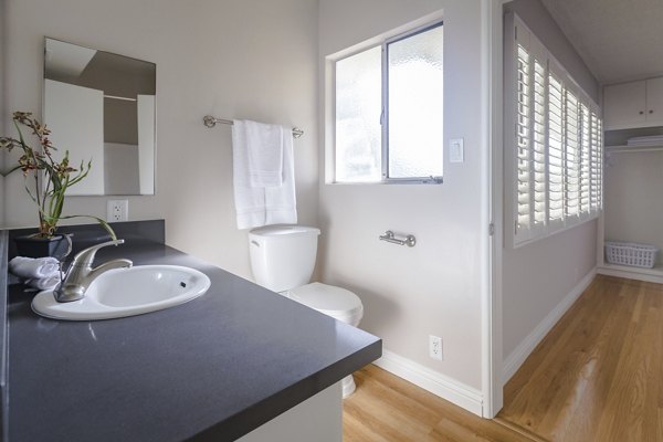 Bathroom with elegant marble countertops and modern fixtures at Orange Grove Circle Apartments