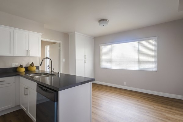 Modern kitchen featuring sleek countertops and stainless steel appliances in Orange Grove Circle Apartments