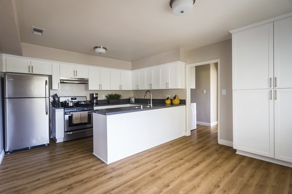 Modern kitchen with stainless steel appliances at Orange Grove Circle Apartments