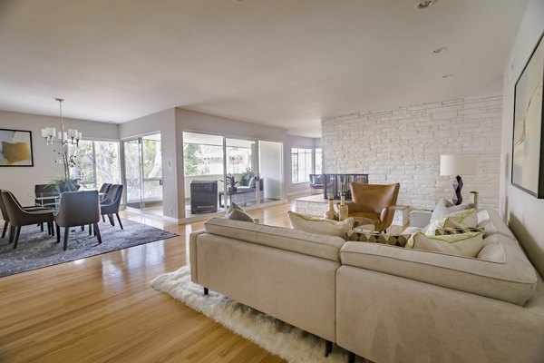 Modern living room with sleek furnishings at Orange Grove Circle Apartments featuring luxury design and ample natural light