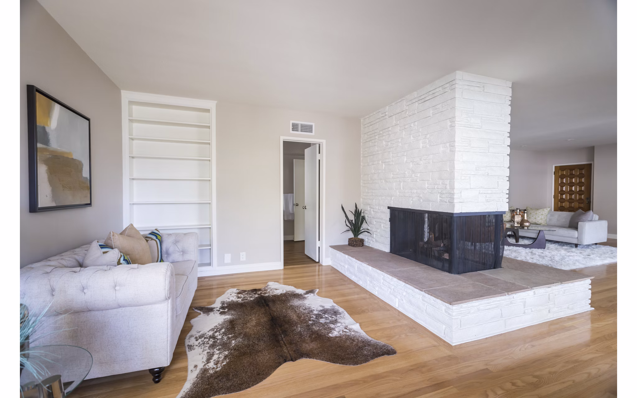Spacious living room with modern decor and large windows at Orange Grove Circle Apartments