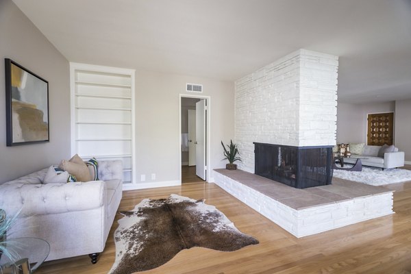 Spacious living room with modern decor and large windows at Orange Grove Circle Apartments