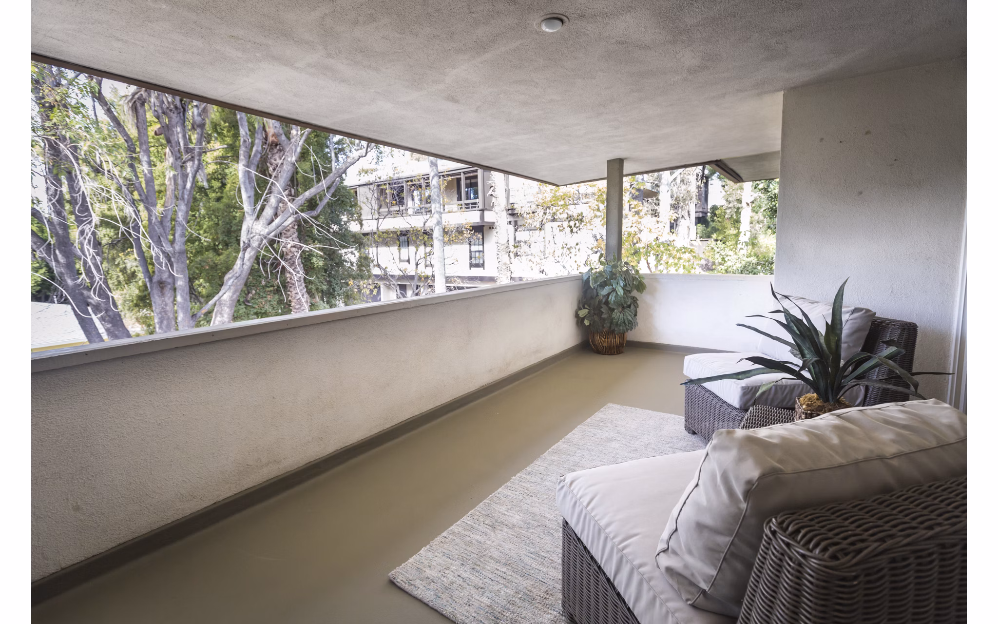 Charming outdoor patio with seating area at Orange Grove Circle Apartments, offering a perfect spot to relax and enjoy the surroundings