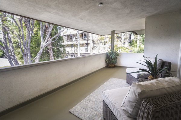 Charming outdoor patio with seating area at Orange Grove Circle Apartments, offering a perfect spot to relax and enjoy the surroundings
