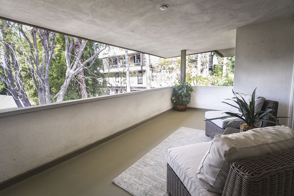 Charming outdoor patio with seating area at Orange Grove Circle Apartments, offering a perfect spot to relax and enjoy the surroundings