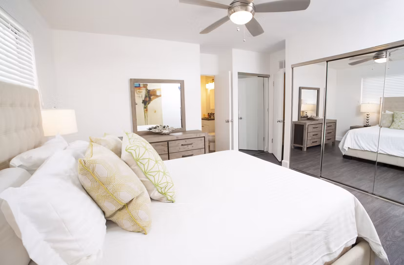 Cozy bedroom with ocean-inspired decor at Pacific Rose Apartments, Greystar luxury property in a vibrant coastal setting