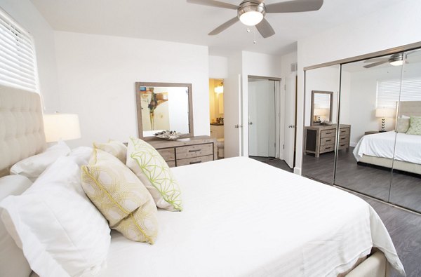 Cozy bedroom with ocean-inspired decor at Pacific Rose Apartments, Greystar luxury property in a vibrant coastal setting