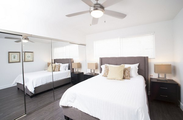 Cozy bedroom with elegant decor at Pacific Rose Apartments featuring luxury living in the heart of a vibrant community
