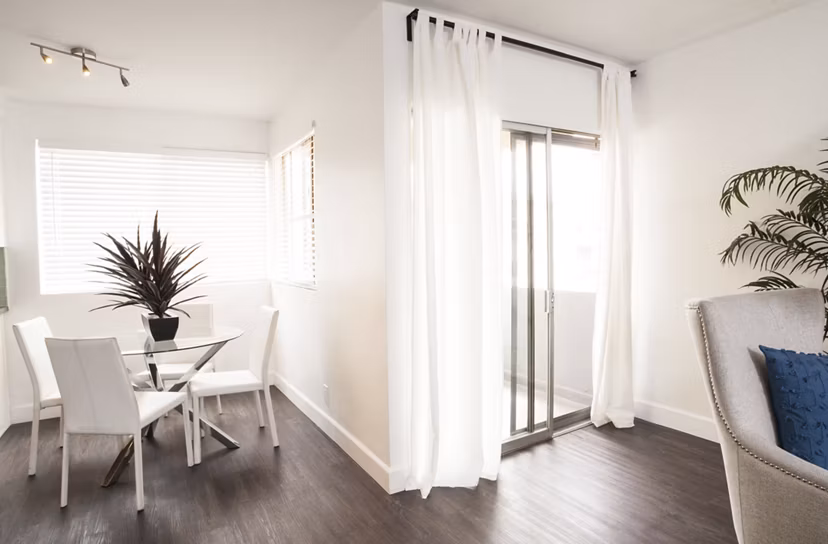 Dining area with modern furnishings and elegant lighting at Pacific Rose Apartments