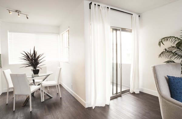 Dining area with modern furnishings and elegant lighting at Pacific Rose Apartments