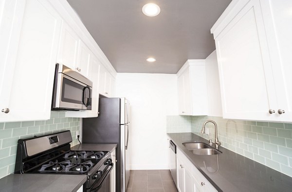 Modern kitchen with stainless steel appliances at Pacific Rose Apartments