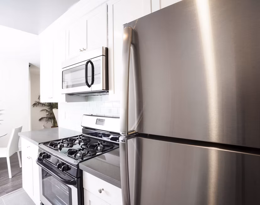 Kitchen featuring stainless steel appliances and granite countertops at Pacific Rose Apartments
