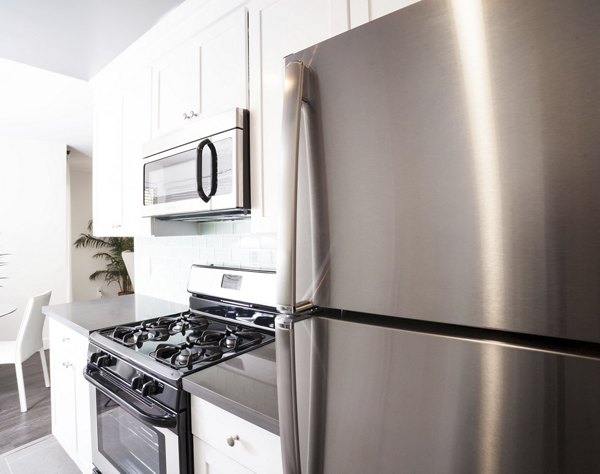 Kitchen featuring stainless steel appliances and granite countertops at Pacific Rose Apartments