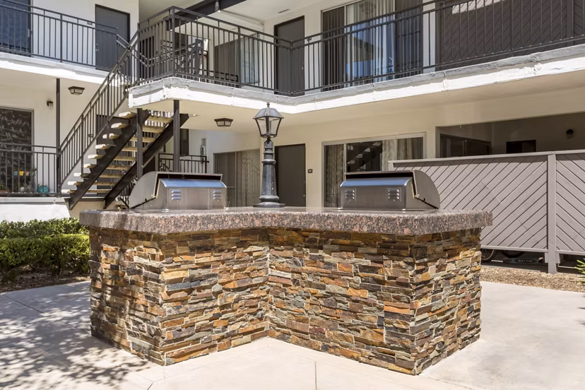 Grill area with outdoor seating at Pacific Rose Apartments with scenic views