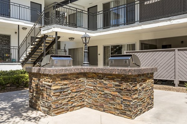 Grill area with outdoor seating at Pacific Rose Apartments with scenic views