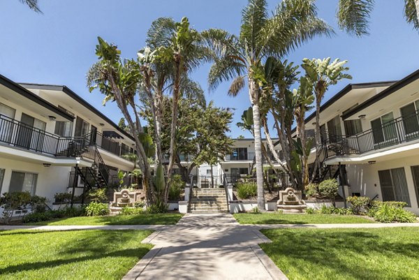 Courtyard with garden and seating area at Pacific Rose Apartments, highlighting serene outdoor spaces for relaxation and leisure