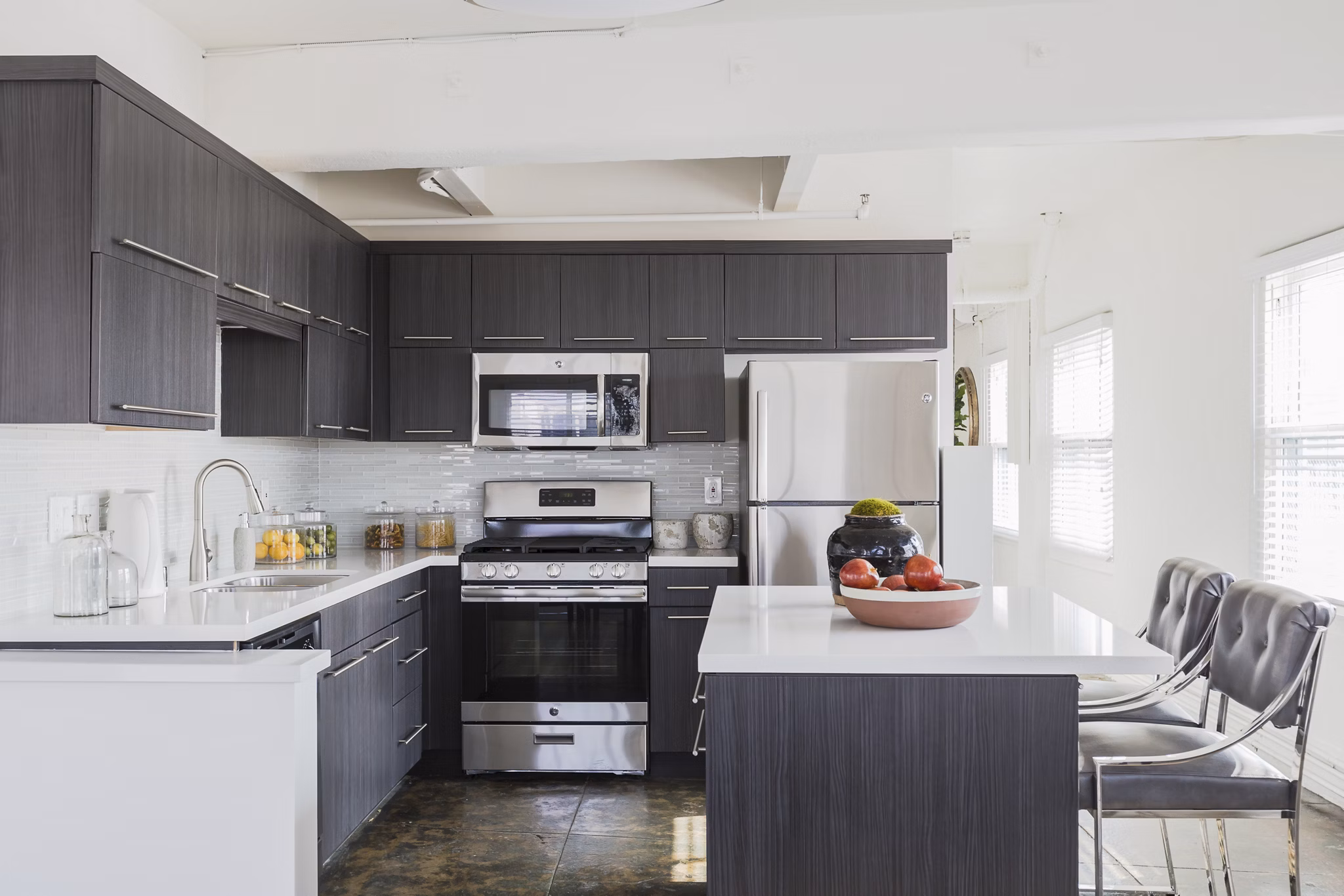 Modern kitchen with sleek countertops and stainless steel appliances in San Fernando Building Apartments