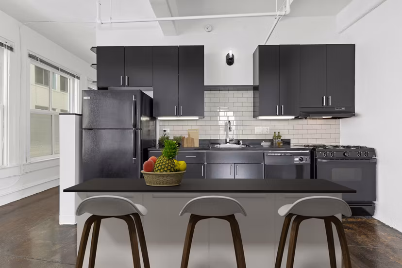 Modern kitchen with stainless steel appliances in San Fernando Building Apartments