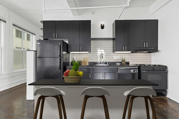Modern kitchen with stainless steel appliances in San Fernando Building Apartments