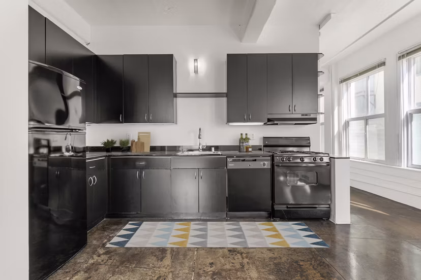 Modern kitchen with stainless steel appliances in San Fernando Building Apartments