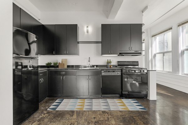 Modern kitchen with stainless steel appliances in San Fernando Building Apartments