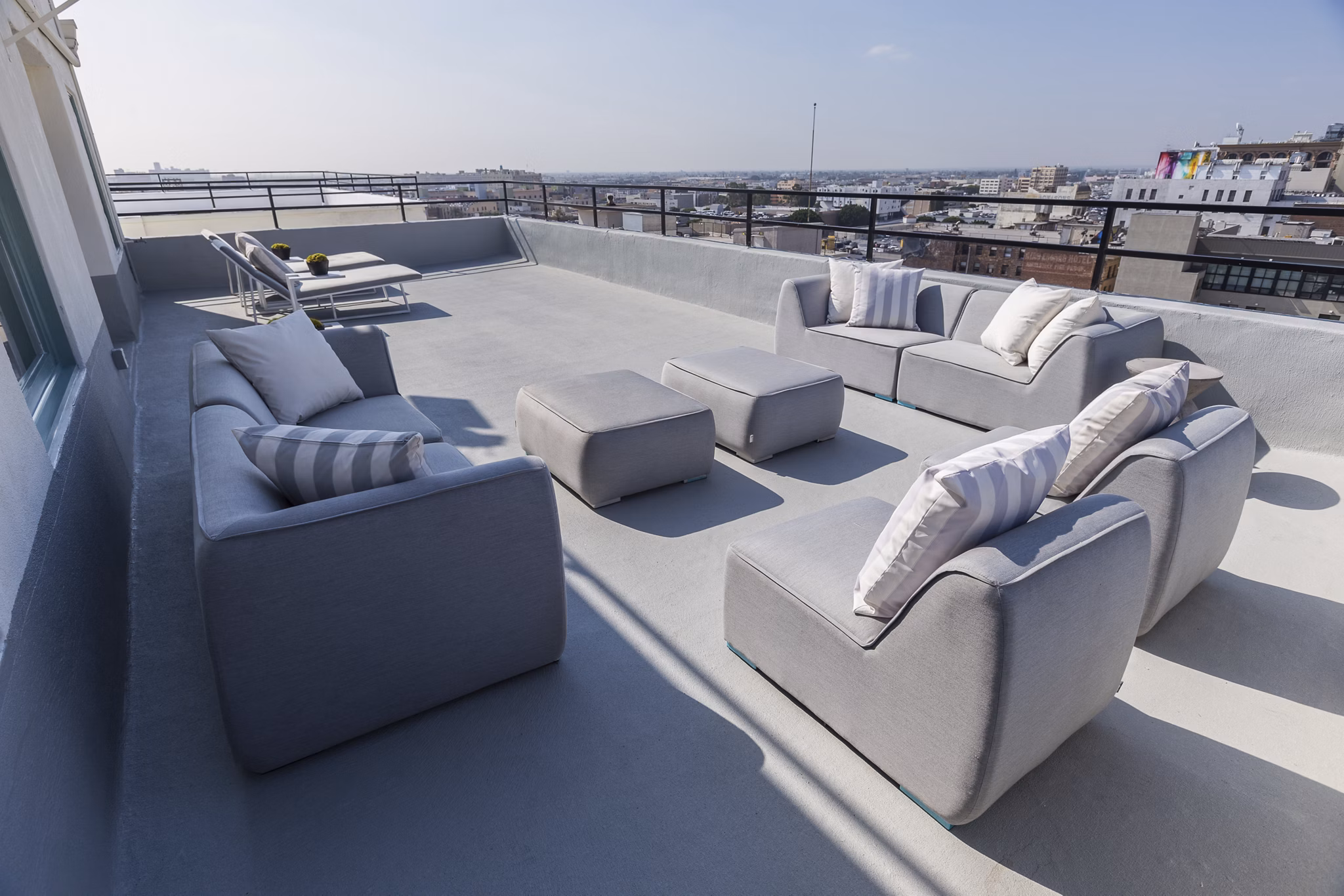 San Fernando Building Apartments: Rooftop deck with seating and city skyline views