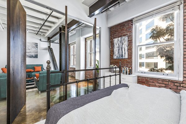 Cozy bedroom with modern design accents at South Park Lofts Apartments, Greystar luxury apartments