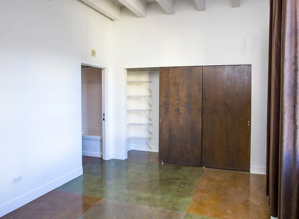 Spacious bedroom closet with modern shelving at South Park Lofts Apartments, luxury living space