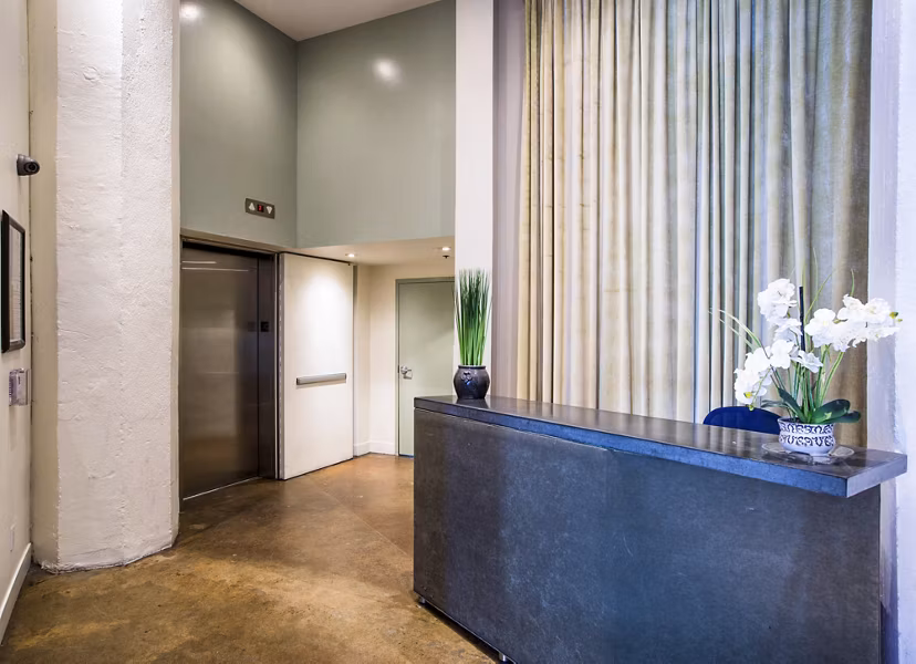 Clubhouse lobby featuring modern furnishings and artwork at South Park Lofts Apartments, ideal for relaxing and socializing