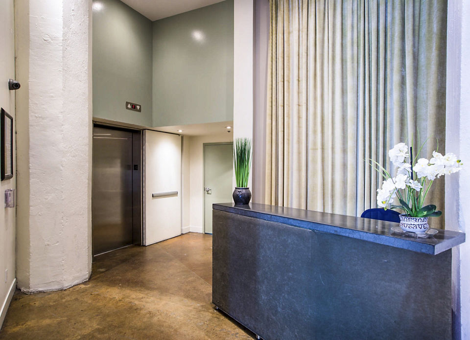 Clubhouse lobby featuring modern furnishings and artwork at South Park Lofts Apartments, ideal for relaxing and socializing