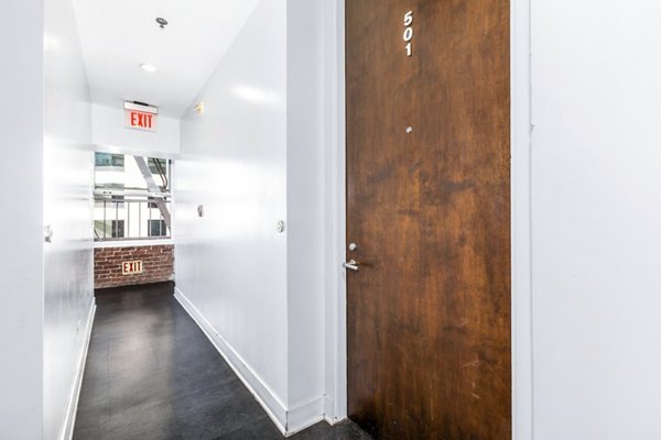 Elegant hallway with modern lighting fixtures at South Park Lofts Apartments