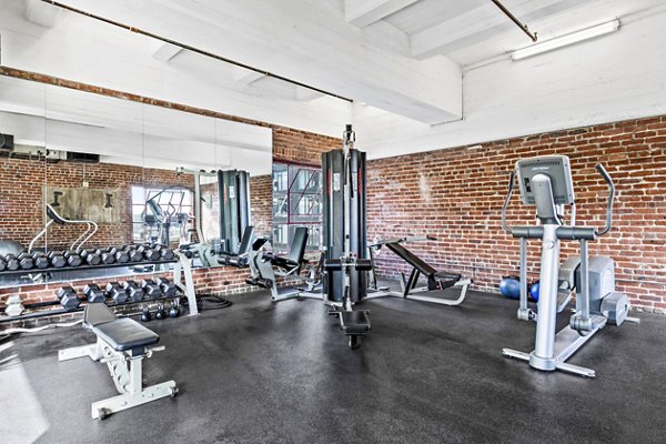 State-of-the-art fitness center at South Park Lofts Apartments featuring modern exercise equipment and spacious workout area