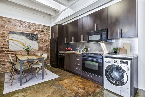 Modern kitchen with stainless steel appliances and granite countertops at South Park Lofts Apartments