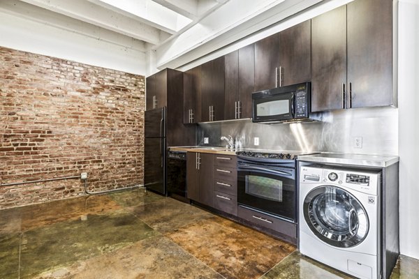 Kitchen with modern appliances and sleek countertops at South Park Lofts Apartments