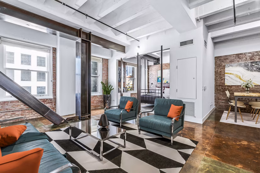 Spacious living room with stylish decor and natural light in South Park Lofts Apartments