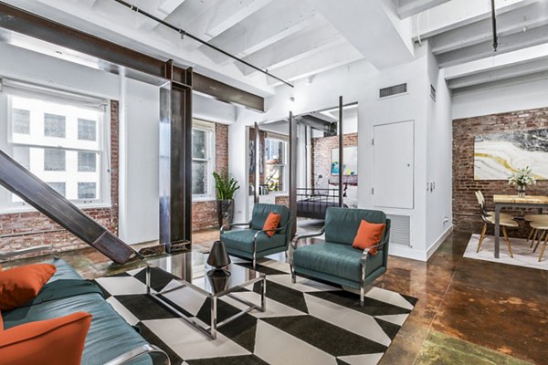 Spacious living room with stylish decor and natural light in South Park Lofts Apartments