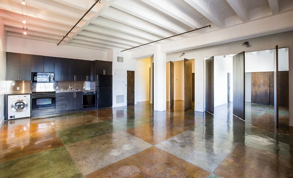 Spacious living room with modern decor and natural light at South Park Lofts Apartments