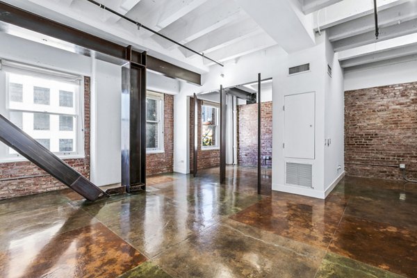 Bright living room with industrial decor at South Park Lofts Apartments