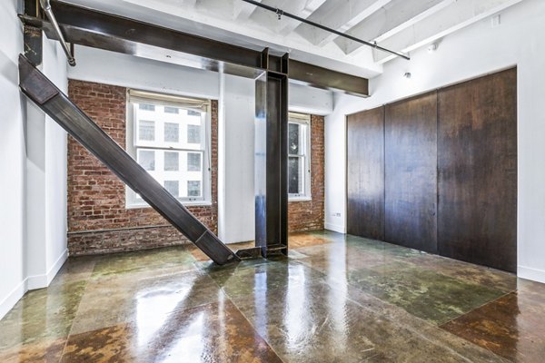 Bright living room with modern decor and large windows at South Park Lofts Apartments