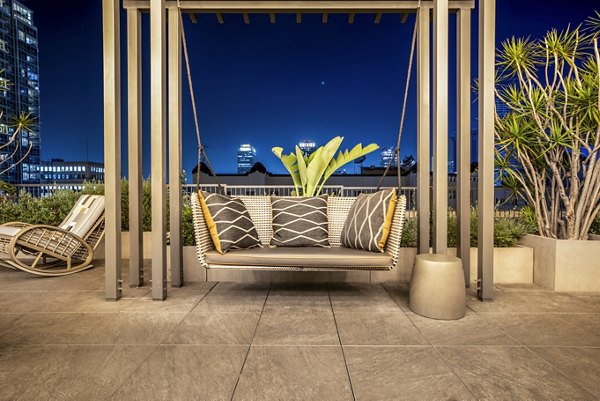 Chic balcony with modern furniture at South Park Lofts Apartments, offering outdoor relaxation and city views