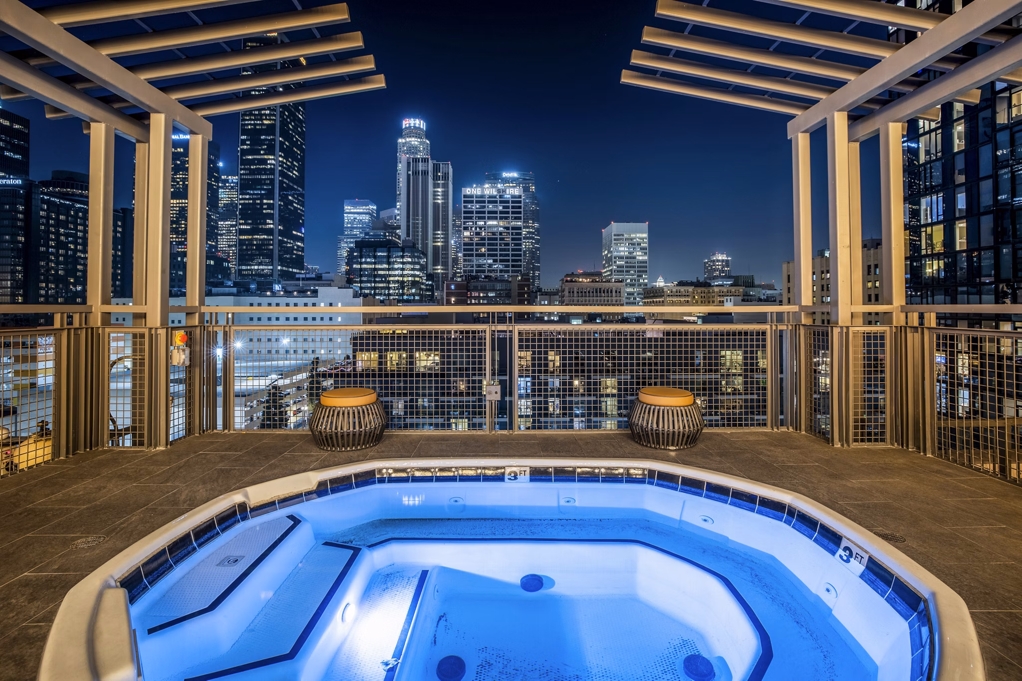 Sunny outdoor pool area with lounge chairs at South Park Lofts Apartments, perfect for relaxation and leisure time