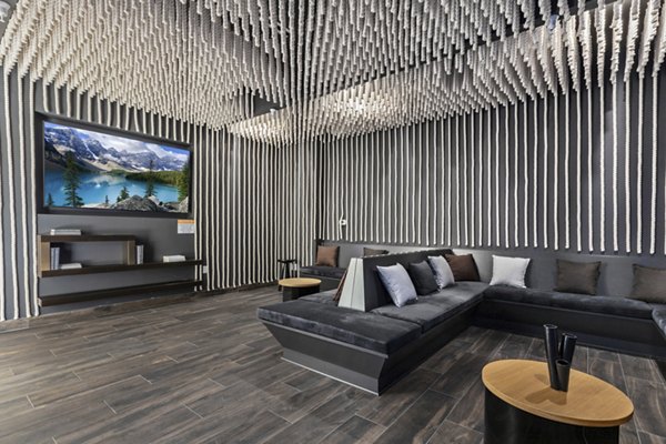 Modern lounge with sleek black furniture and unique ceiling design at The View Apartments, a Greystar luxury community